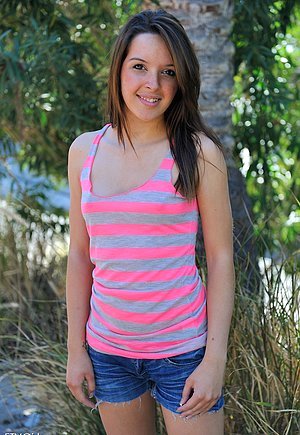 Cutesy brunette in a striped outfit shoves a pink toy in her hot little cun