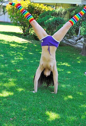Blue-eyed babe doing splits and cartwheels while naked outdoors