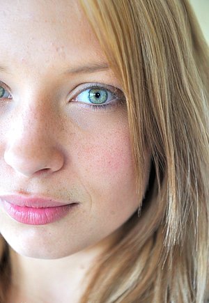 Blond-haired chick in white knee-highs pulling out her pussy lips