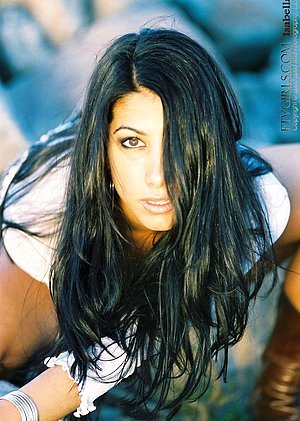 Dark-haired Latina exposes her slightly hairy pussy while on the rocks