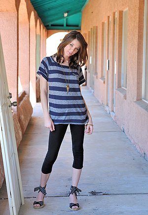 Adorable teen in a striped t-shirt shows her small breasts outdoors