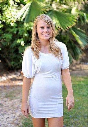 Tanned blonde with tight abs riding a flesh-colored toy on camera