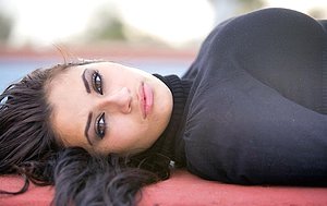 Dark haired girl with long legs exposing herself while outdoors